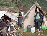 14 1 Yak Herders And Egg Lady, Jerome Ryan Drinking Tea At Pethang camp As I drank my milk-tea the next morning, I watched �The Egg Lady� start their fire with small branches and pieces of wood, and cooked in blackened pots balanced between rocks. She wore the typical Tibetan chuba, a black robe reaching from her shoulders to the top of her flimsy green Chinese sneakers, held together with a wide belt made of multi-coloured cloth on the back and silvery metal on the front, a long dark apron, and bright green long sleeved top. Her hair was braided and held in a bun with a coloured piece of cloth. The other six were still under their blankets beneath the tarp, all huddled close together sleeping head to head crossways.
